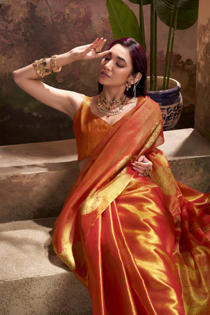 Woman posing in red tissue silk saree with zari weaving butta highlighting rich texture and graceful drape