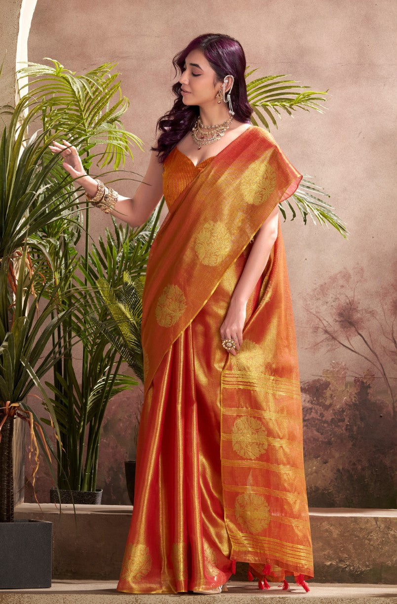 Model posing in red tissue silk saree with zari butta and border pallu showing full length wedding and party styling