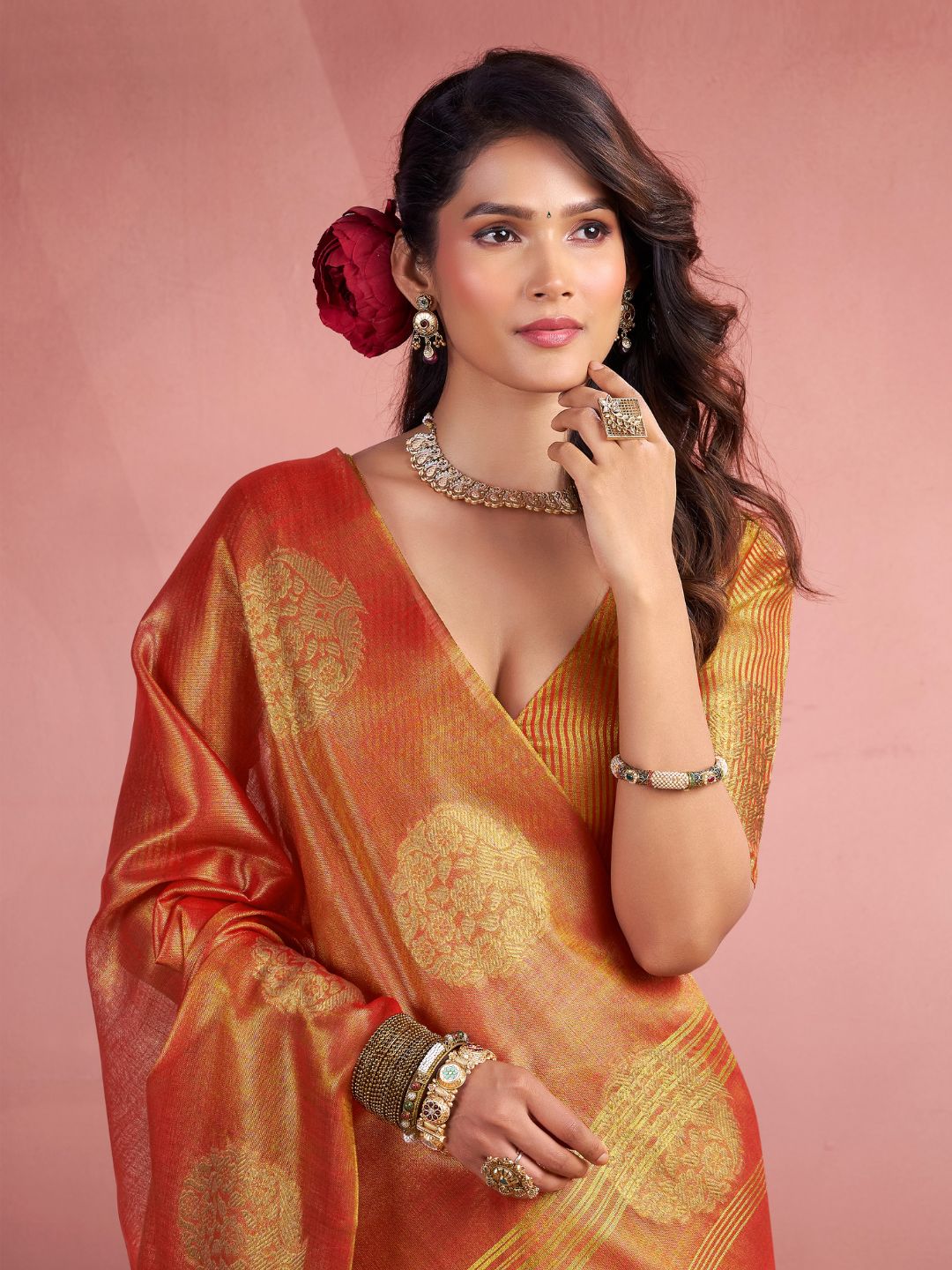 Side portrait of red tissue silk saree with fancy zari weaving butta highlighting graceful drape