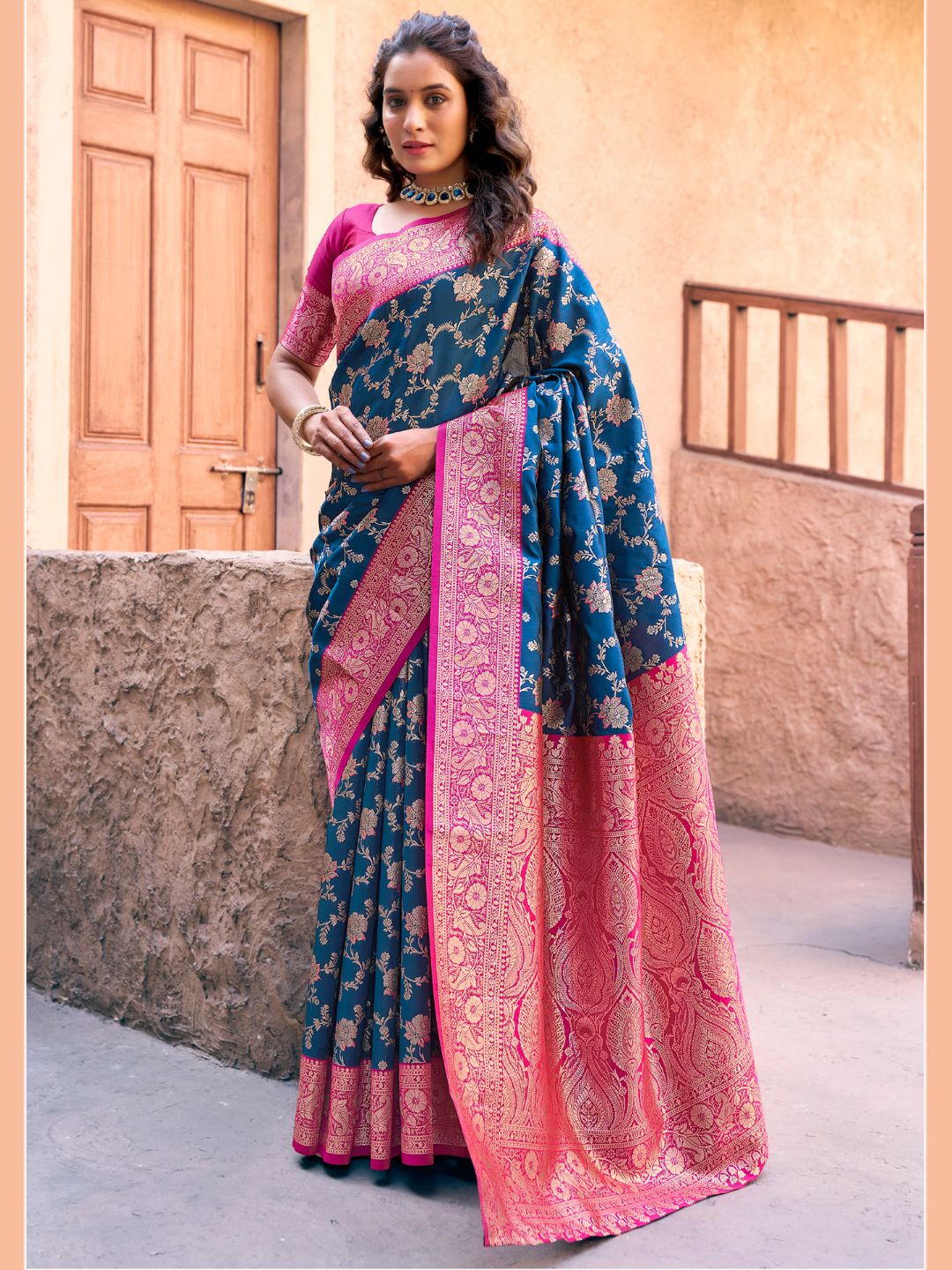 Model posing in royal blue Banarasi silk saree with Warli work showing full length wedding and festive styling