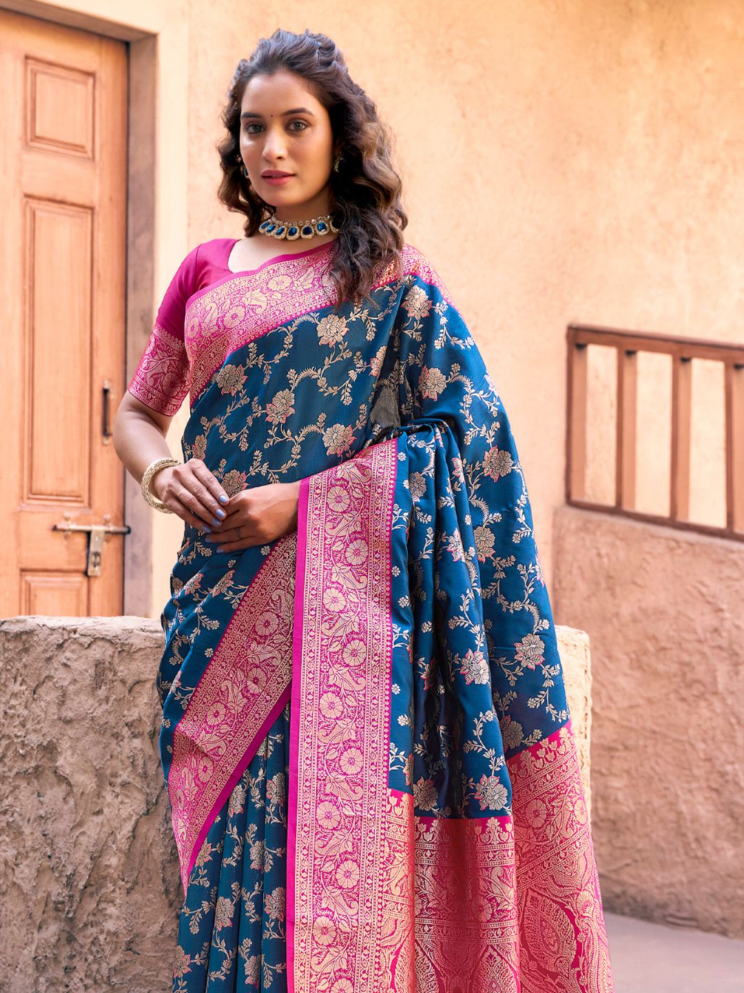 Side view of royal blue Banarasi silk saree with Warli weaving work showcasing graceful drape