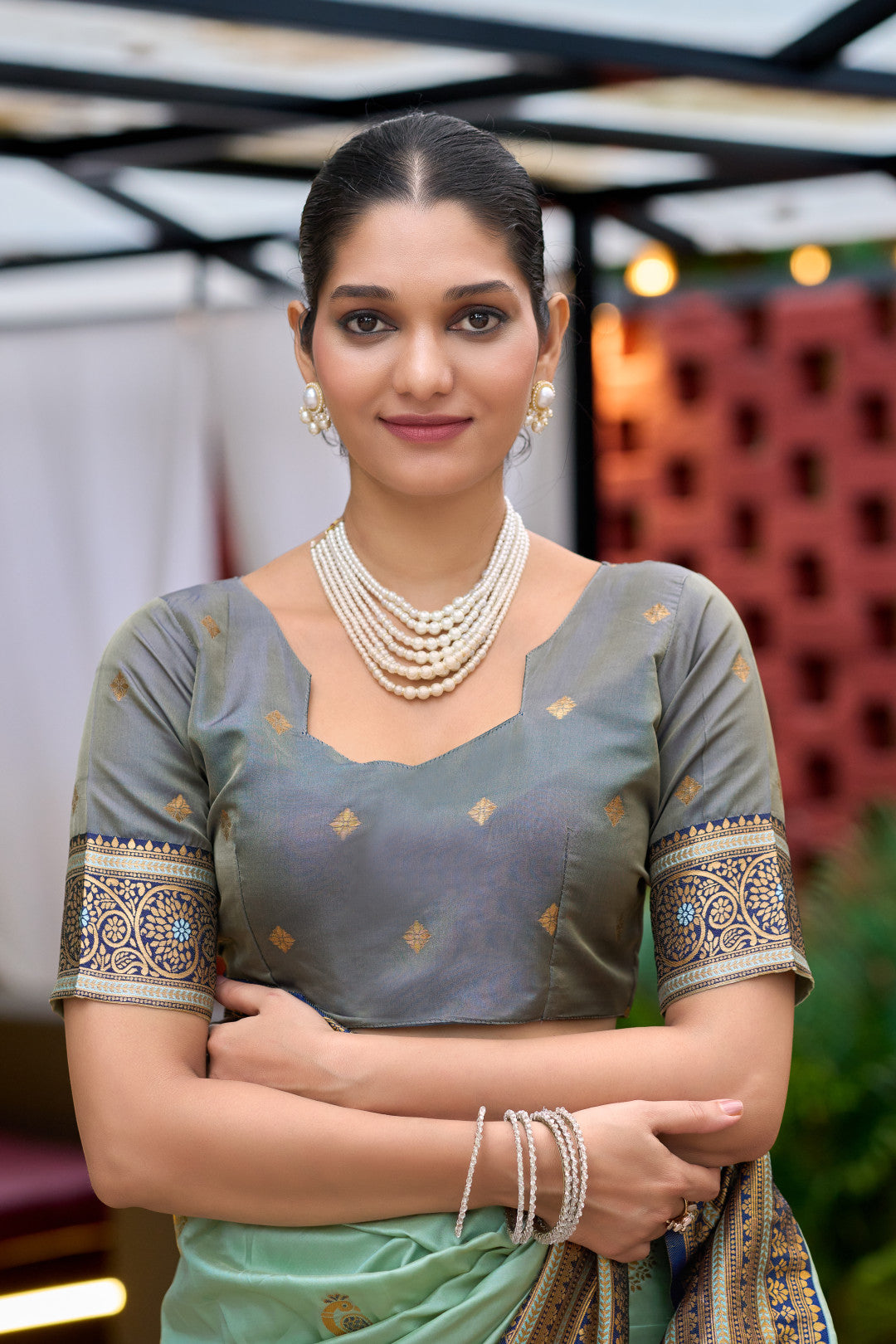 Closeup look of sea green Banarasi silk saree blouse with zari weaving work