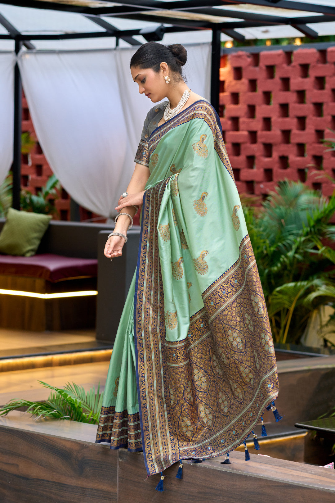 Sea green Banarasi silk saree with zari border in flowing walking drape look