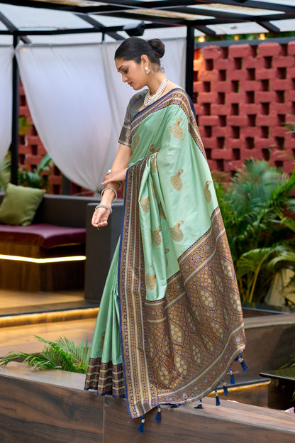 Sea green Banarasi silk saree with zari border in flowing walking drape look