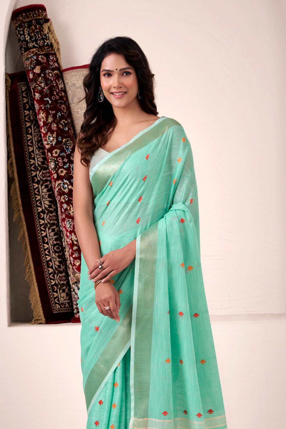 Model posing in sea green linen silk saree with zari work showing full length ethnic styling