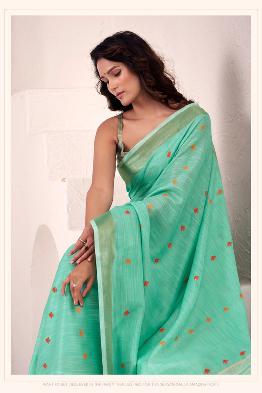 Close view of sea green linen silk saree with zari weaving showcasing elegant drape and detailing