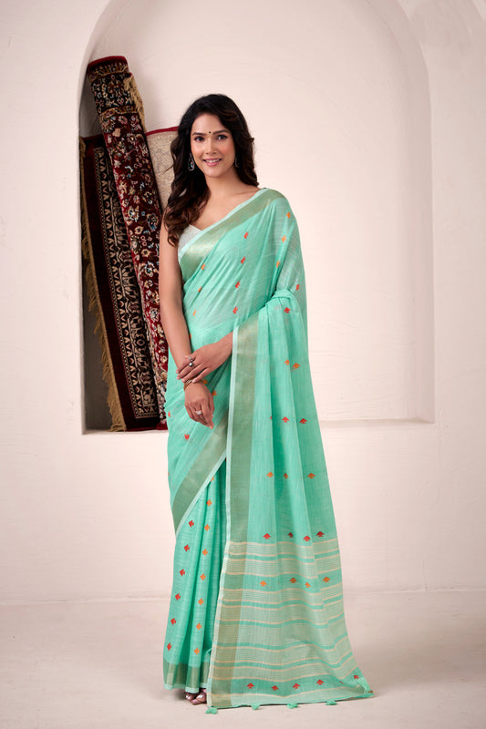 Woman wearing sea green soft linen silk saree with zari weaving and elegant lining pallu full view