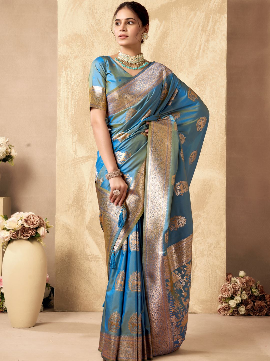 Model posing in sky blue Banarasi silk saree with Warli work showing full length wedding and festive styling