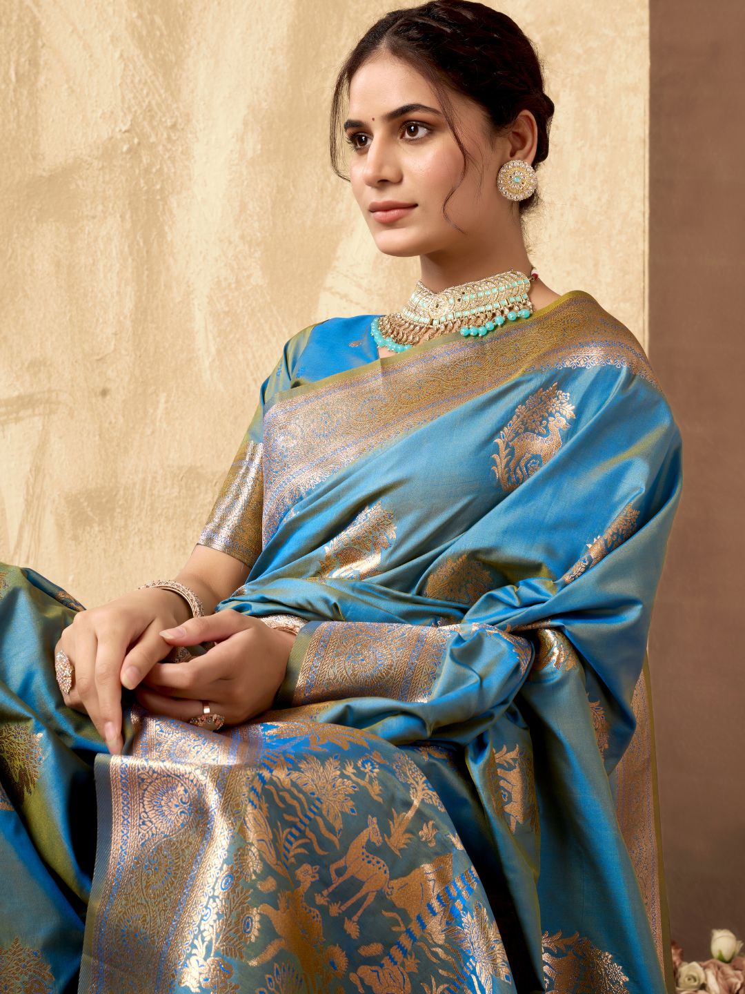 Close upper view of sky blue Banarasi silk saree showcasing Warli weaving work and zari detailing