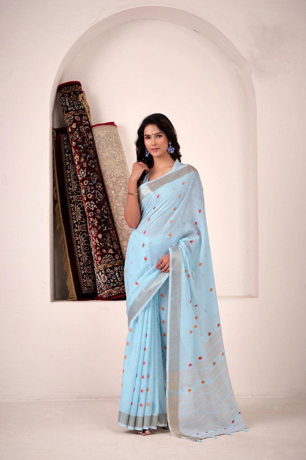 Woman wearing sky blue soft linen silk saree with zari weaving and elegant lining pallu full view