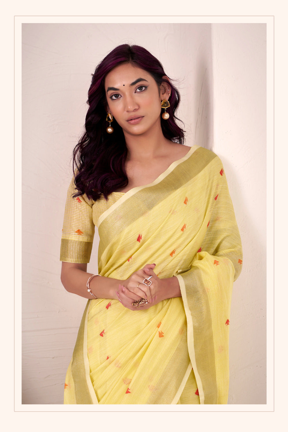 Yellow linen silk saree with zari weaving showcasing close styling pose and graceful drape