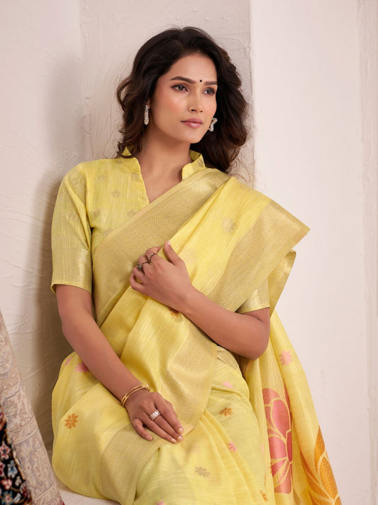 Close view of yellow linen silk saree showcasing floral pallu design and soft fabric texture