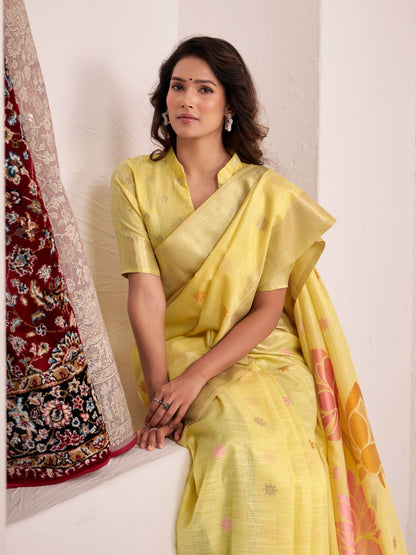 Model posing in yellow soft linen silk saree with floral pallu showing full length elegant styling