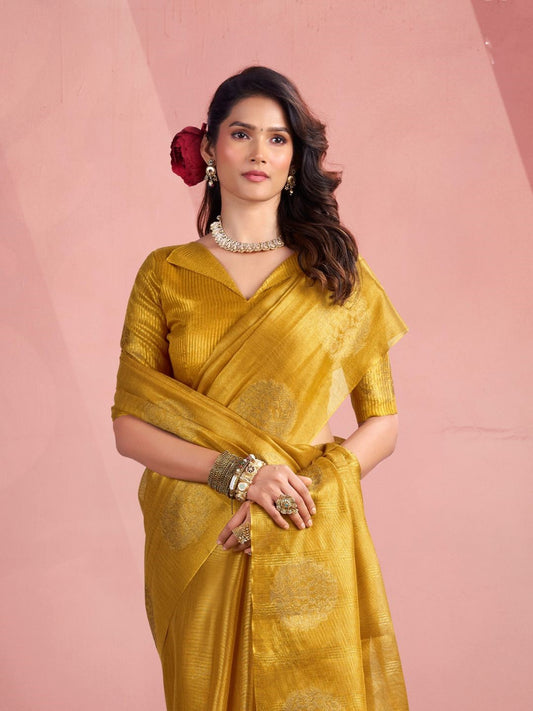 Model posing in yellow tissue silk saree with zari butta showcasing elegant party wear styling