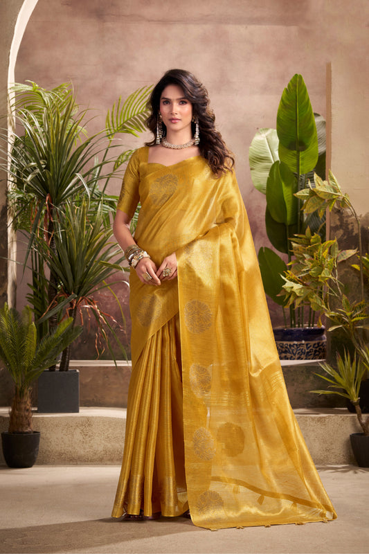 Woman wearing yellow tissue silk saree with zari weaving butta and zari border pallu full front view