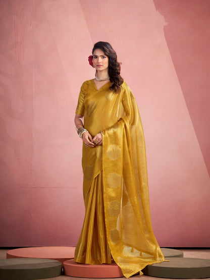 Woman wearing yellow tissue silk saree with fancy zari weaving butta full front view