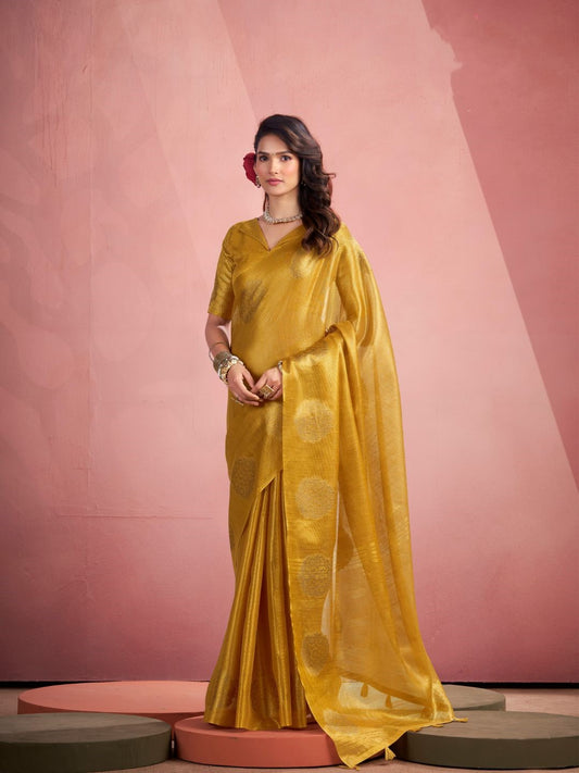 Woman wearing yellow tissue silk saree with fancy zari weaving butta full front view